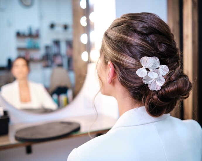 View of a woman having a hairstyle with stylish hair accessories at the hair salon.